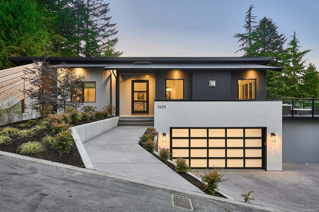 Modern single-family home by White Wolf Homes with elevated entrance and two-car garage in Victoria,.
