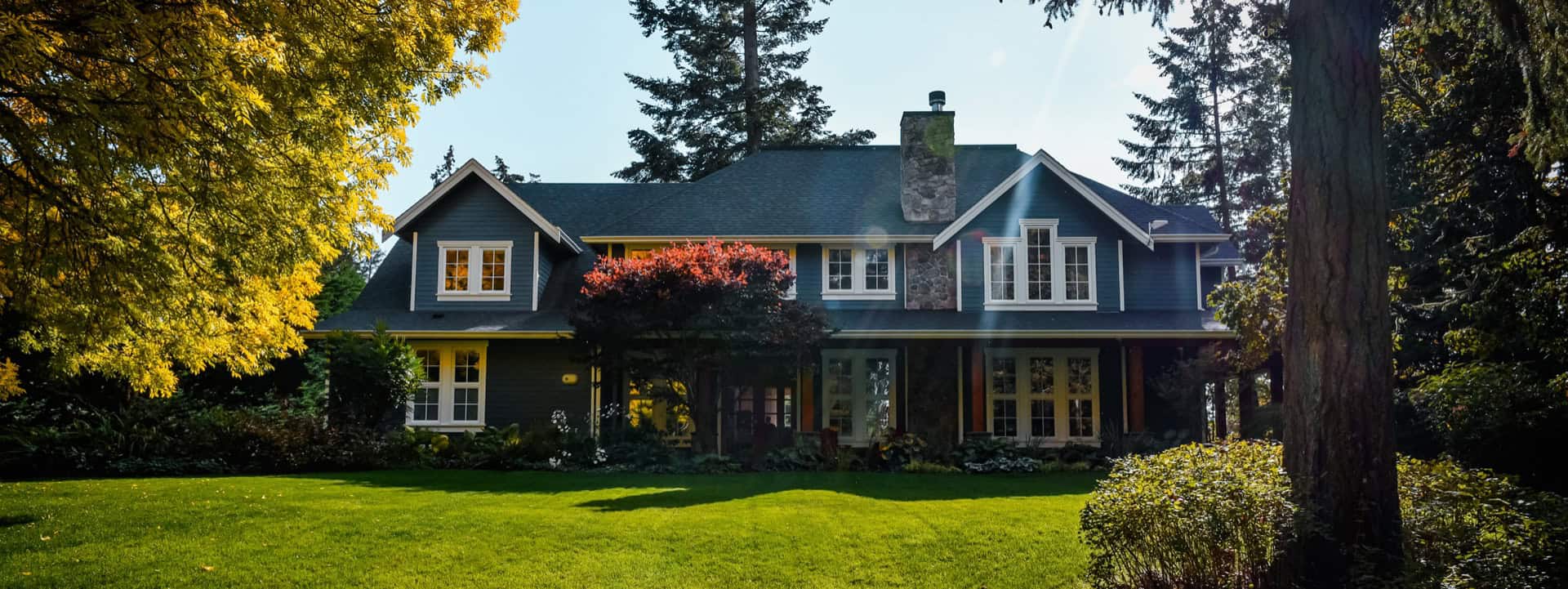 White Wolf Homes custom home exterior in Victoria BC with lush landscaping.