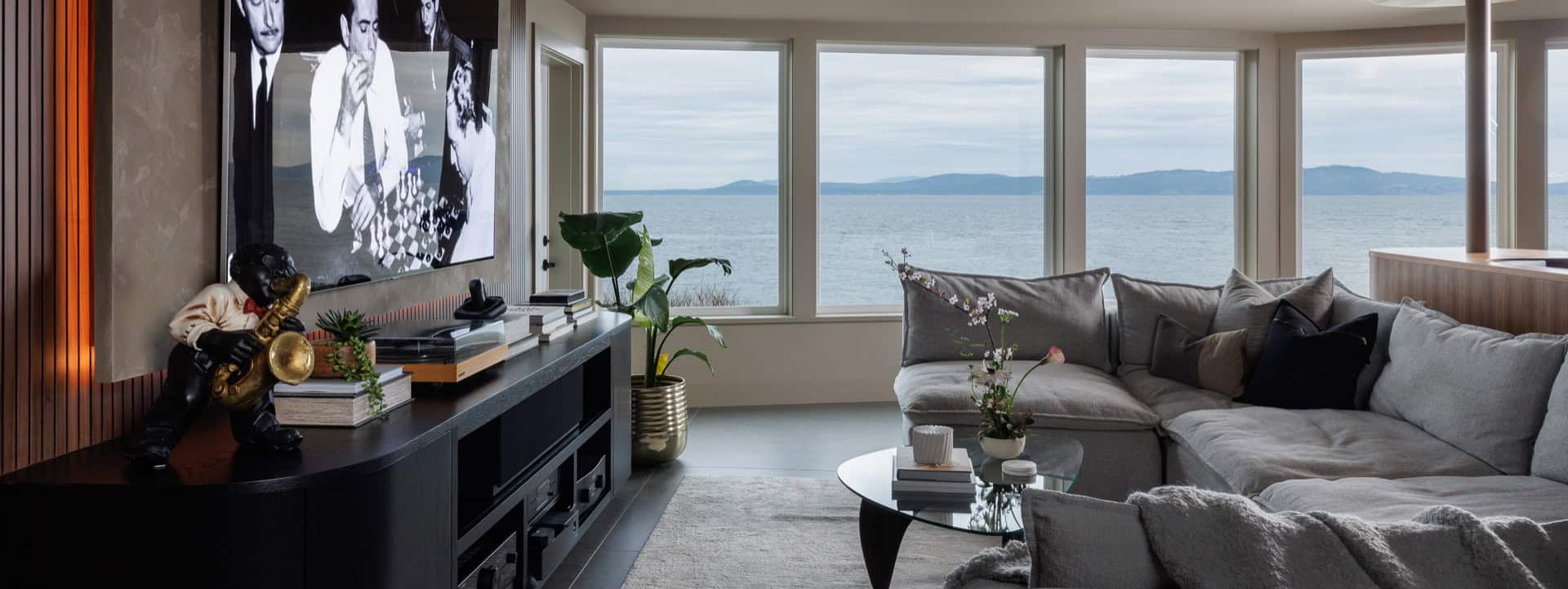 Modern living room with large windows and ocean view in Victoria BC.