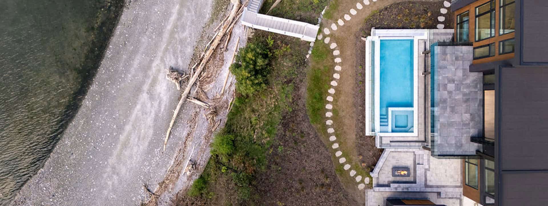 Aerial view of a modern coastal villa by White Wolf Homes Victoria BC.