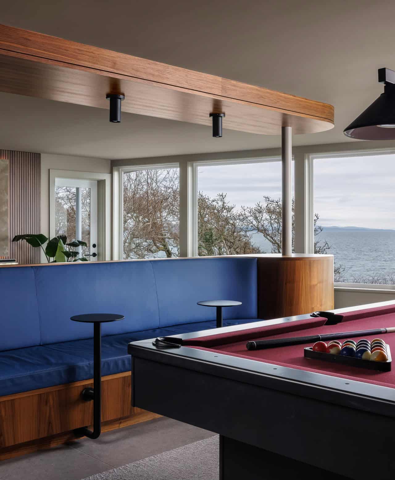 Modern game room with pool table and panoramic ocean view in Victoria BC home.