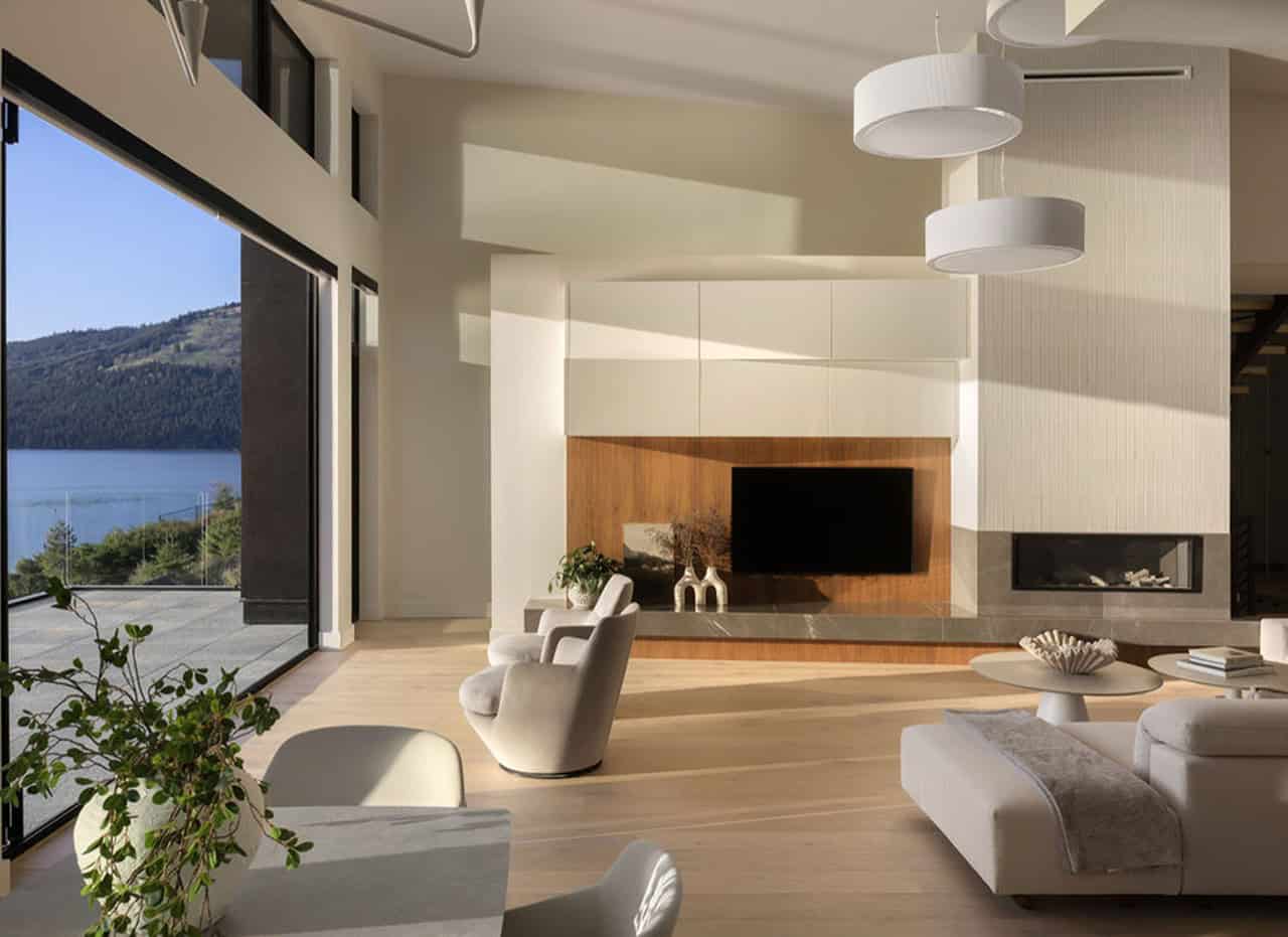Modern living room with large windows and scenic views for Victoria BC custom homes by White Wolf.