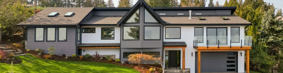 Victorian BC custom home exterior by White Wolf Homes with modern design and large windows.