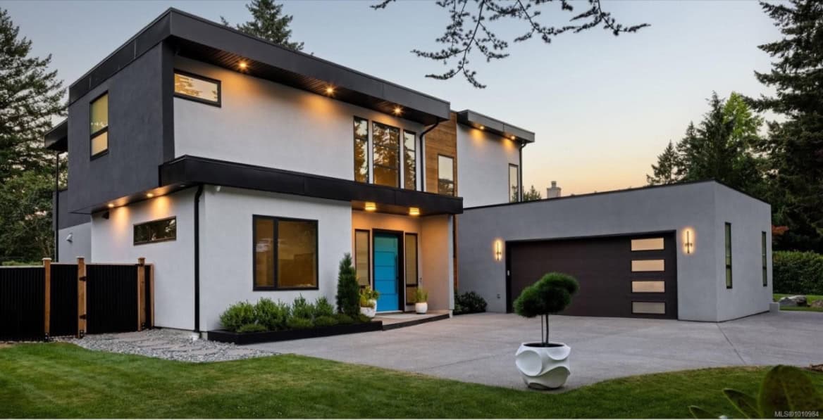 Modern two-story custom home by White Wolf Homes in Victoria BC with sleek design and attachedgarage.