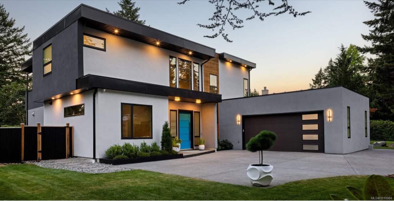 Modern two-story custom home by White Wolf Homes in Victoria BC with sleek design and attachedgarage.