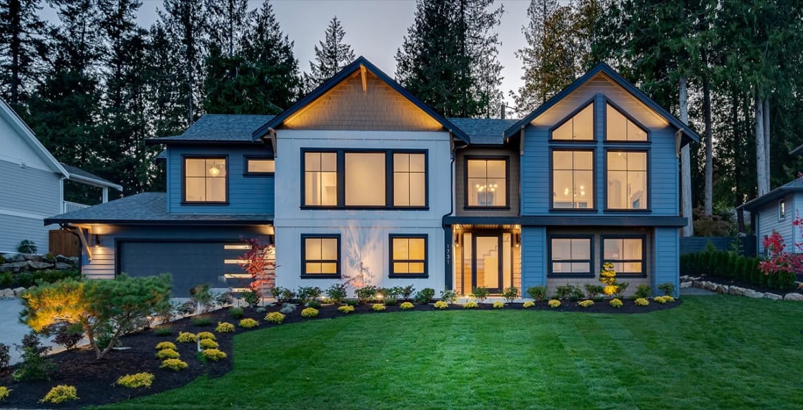 White Wolf Homes custom modern two-story house in Victoria BC with dark siding and large windows.