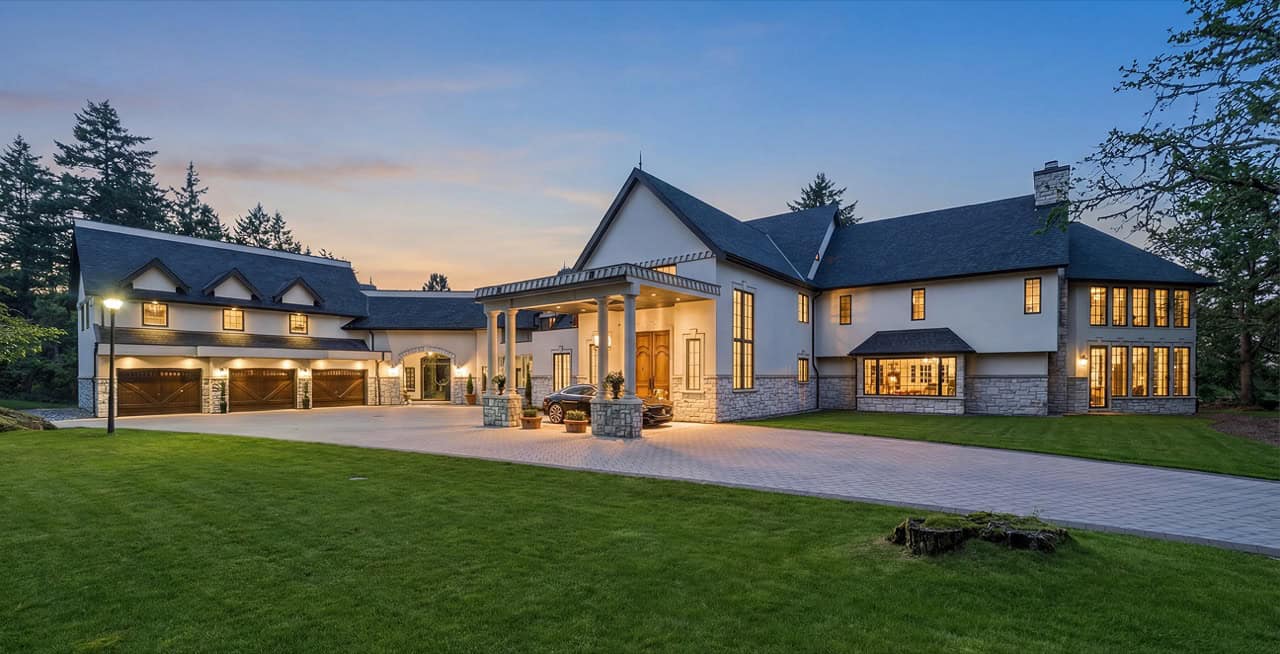 White Wolf Homes custom home exterior in Victoria BC with sunset light illuminates entrance and two-.