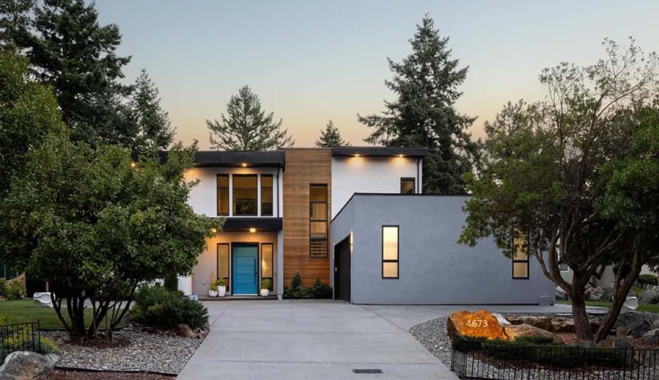 White Wolf Homes modern house in Victoria BC with stone pathway and green landscaping.