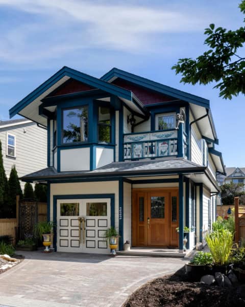 Victoria BC custom home with blue trim, double garage and front porch, modern craftsman style by He/.