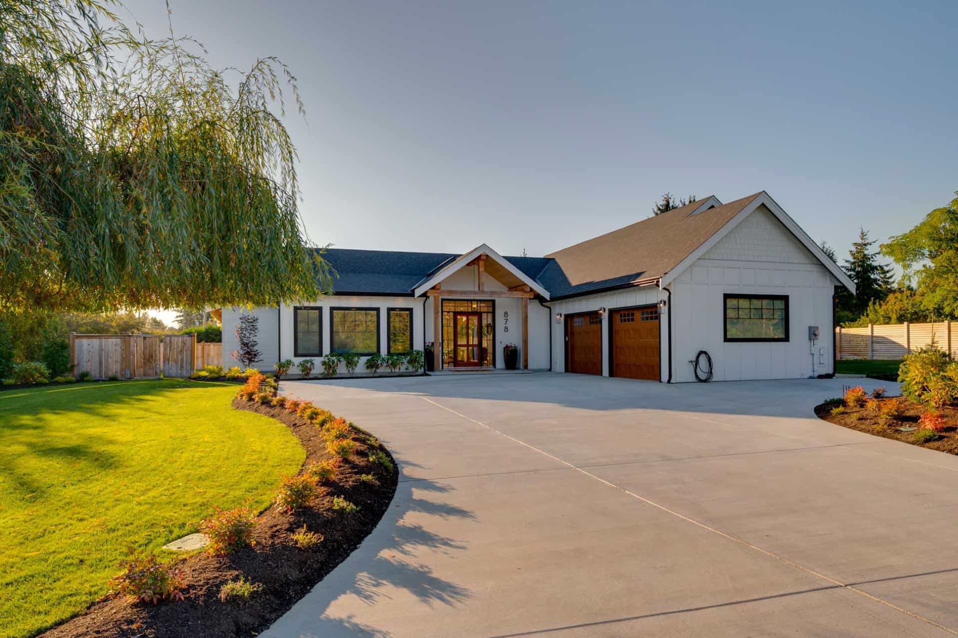 Victoria BC custom home exterior by White Wolf Homes, Willowmere residence with curved driveway and.