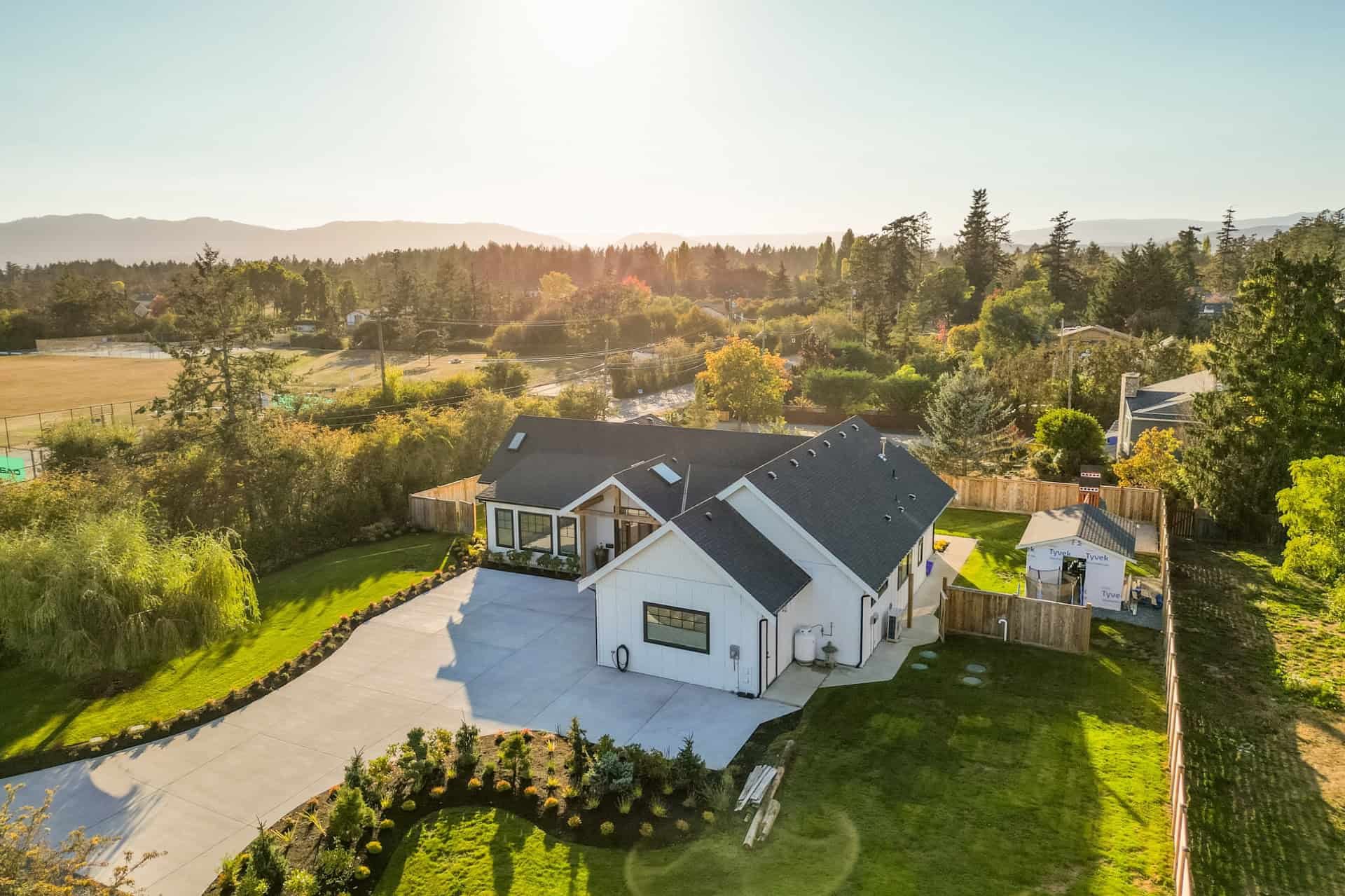 White Wolf Homes custom home in Victoria BC with spacious driveway and lush landscaping.
