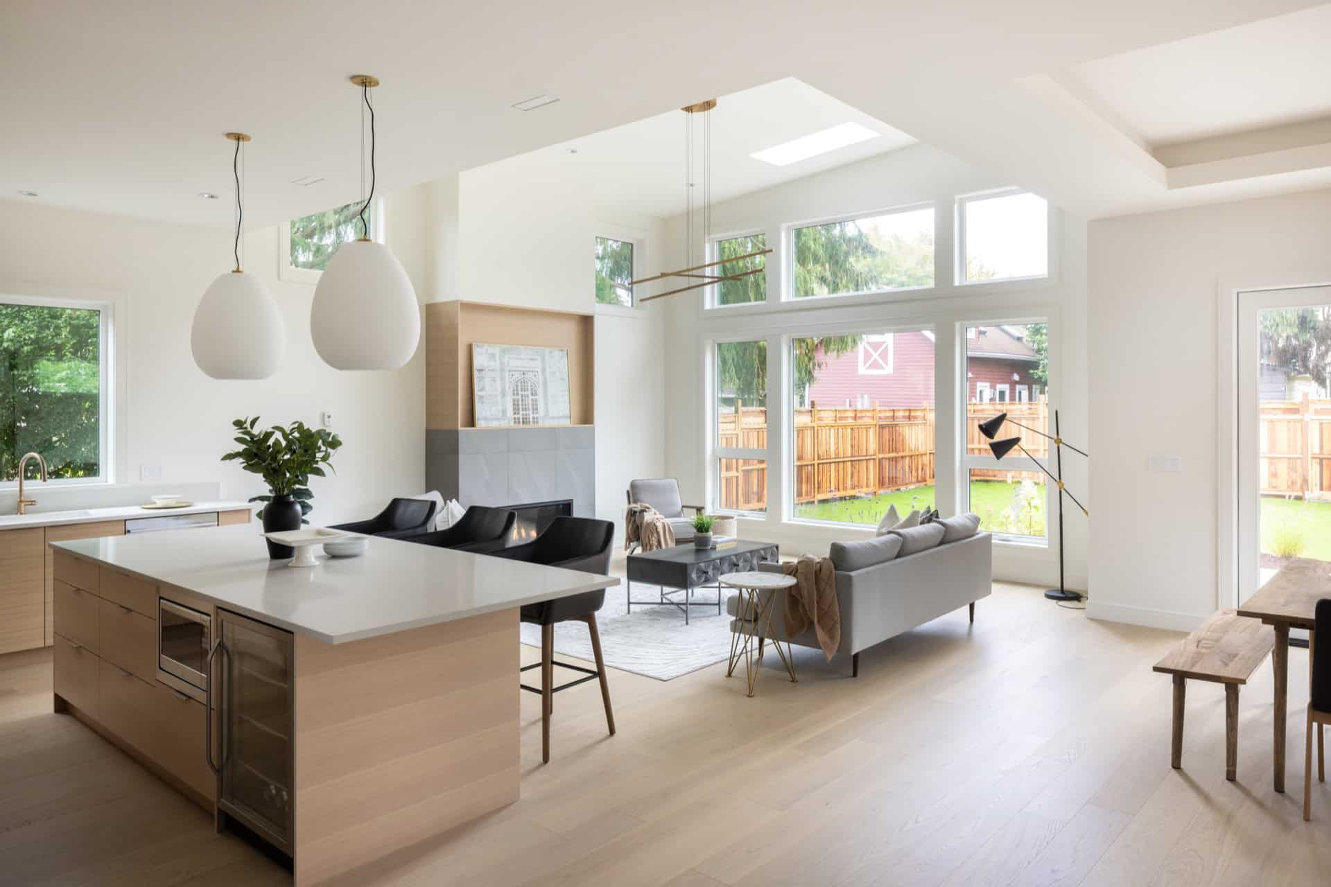 Bright open-concept living space with large windows and modern kitchen island.