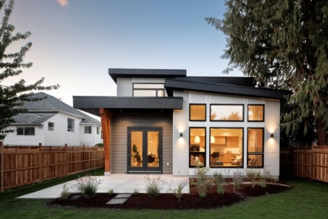 Modern Victoria BC home by White Wolf Homes with warm interior glow.
