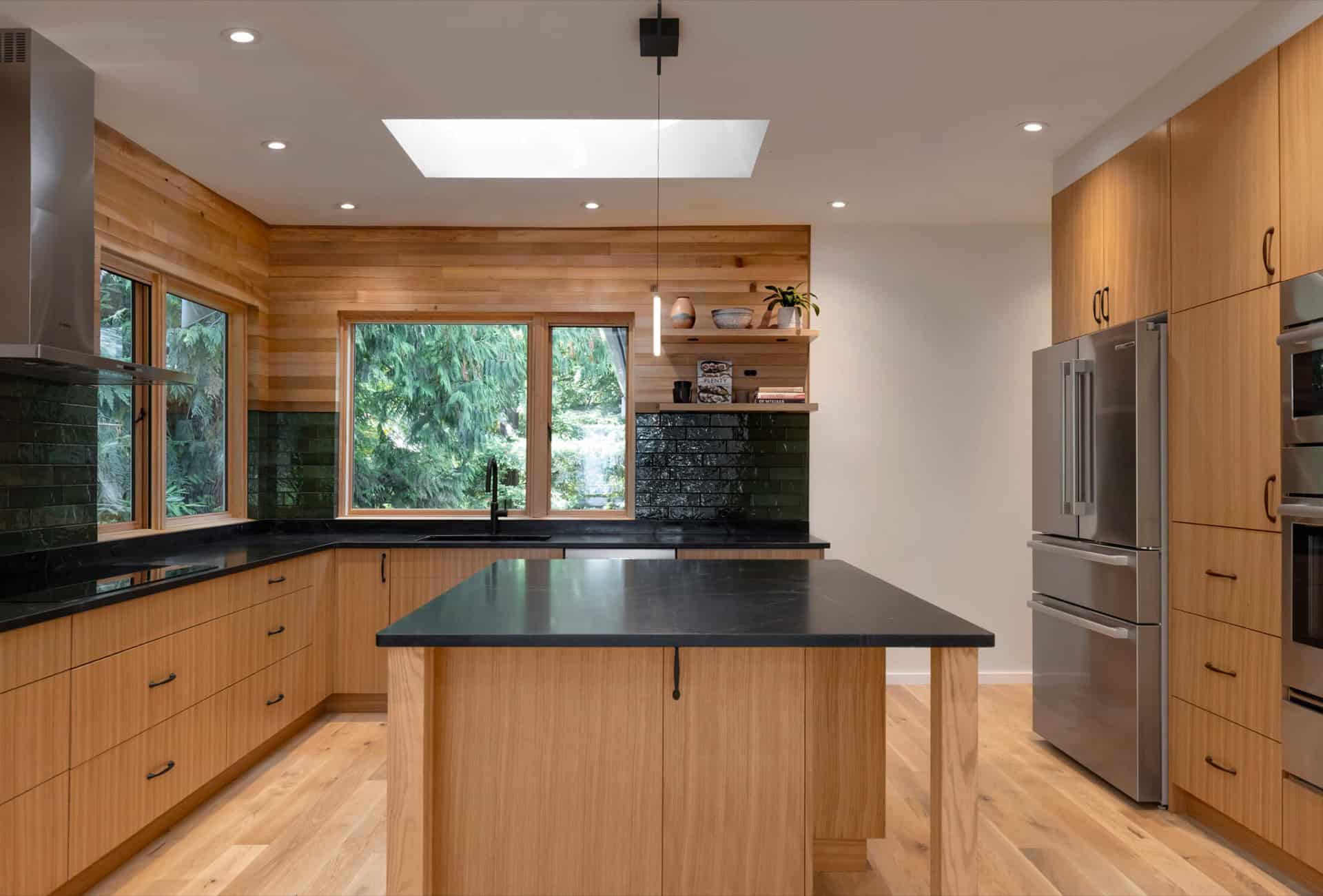Modern kitchen with wooden cabinetry and island in Indigo project by White Wolf Homes.