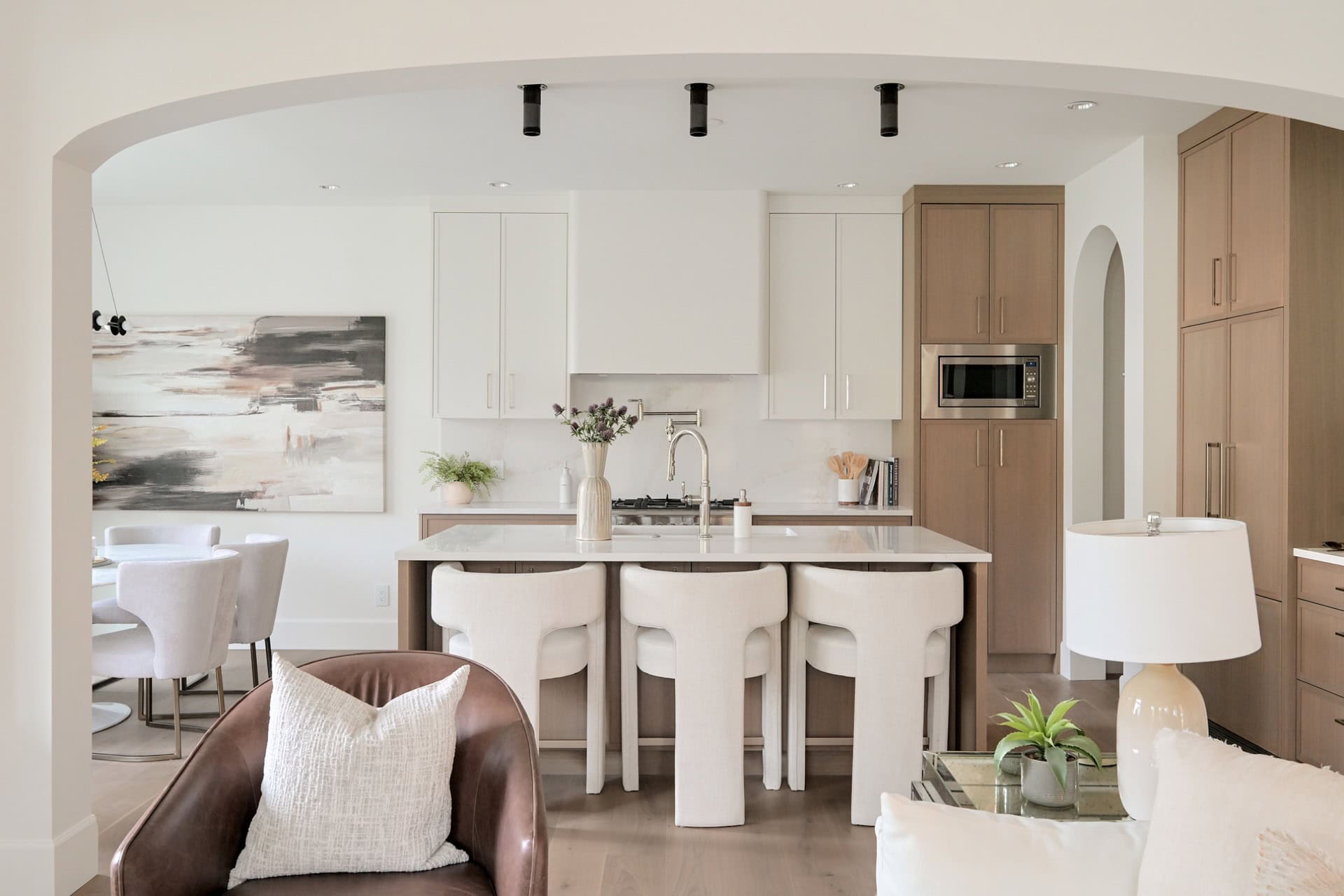 Modern open-concept kitchen with island and dining area in Victoria BC home.