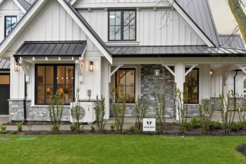White Wolf Homes custom home facade in Victoria BC with stone accents and white siding.