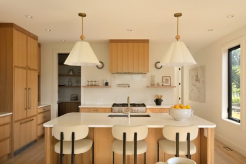 Bright, modern kitchen with wooden cabinetry and island seating in Oakdowne, Victoria BC.