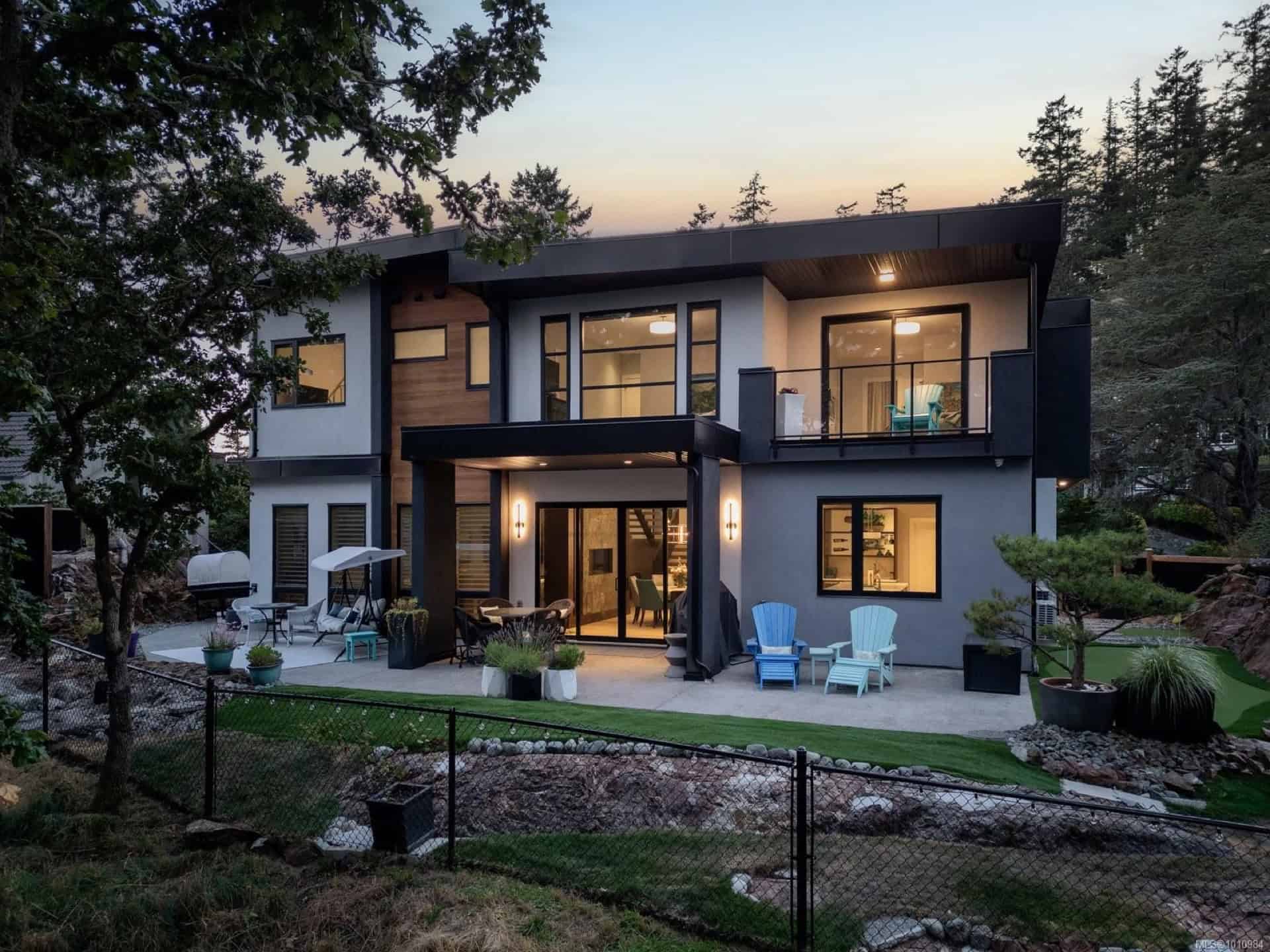 Modern two-story home exterior with patio and landscaped yard in Victoria BC.
