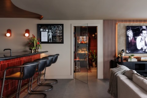 Modern living area with bar seating and art, showcasing Victoria BC home design.