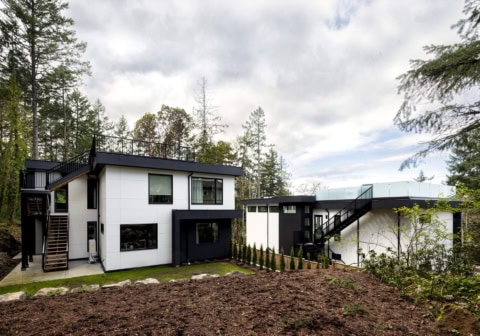 Modern two-story custom home exterior by White Wolf Homes in Victoria BC with white and black siding.