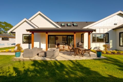White Wolf Homes designed backyard with covered patio and seating in a modern Victoria BC home.