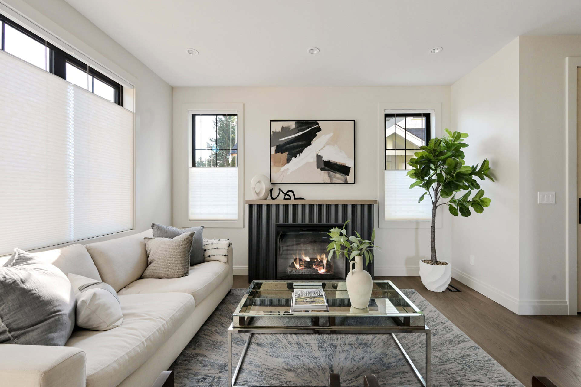 Living room interior with white sofa, fireplace, and modern decor in Victoria BC home.