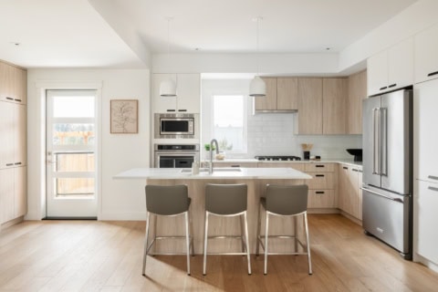 White Wolf Homes kitchen in Arbor Hill: modern bright space with island, light wood cabinets, and 4k.