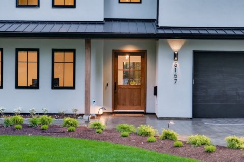 Custom home entrance by White Wolf Homes in Victoria BC, Stillwood, featuring wooden door, modern窗风,.