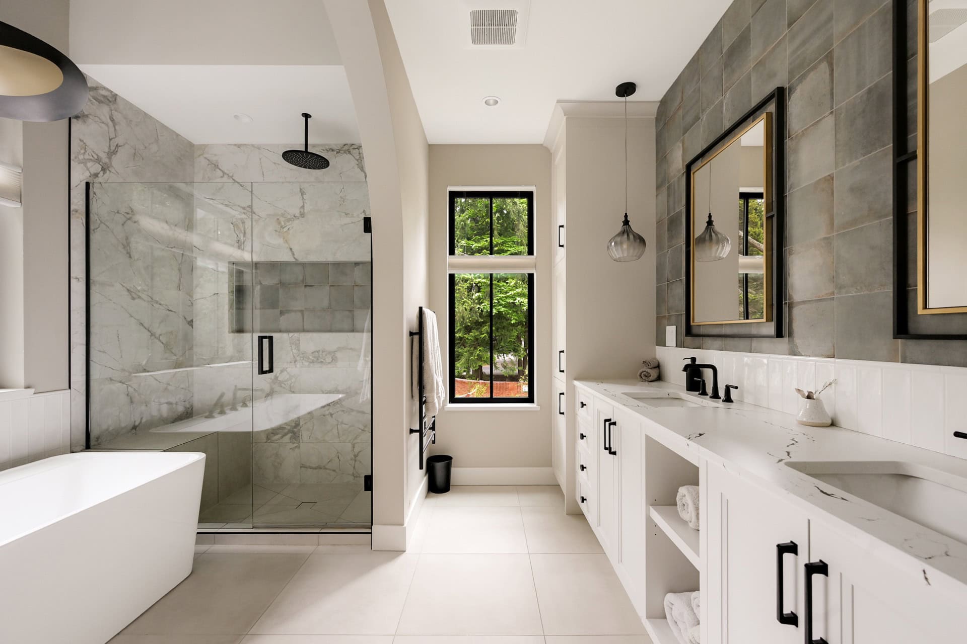Modern ensuite bathroom with walk-in shower, freestanding tub, and double vanity by White Wolf Homes.