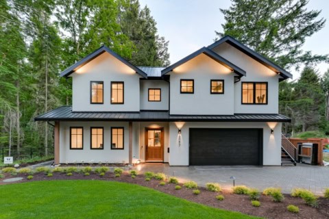 White Wolf Homes modern two-story home in Victoria BC with white and gray siding, dark roof, large 3.