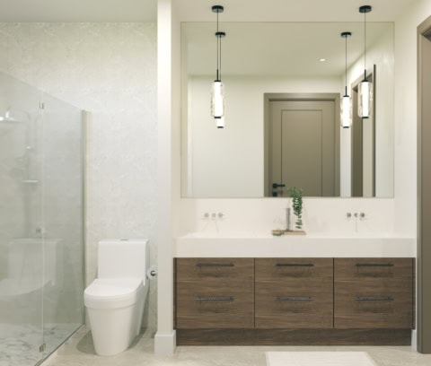 Modern bathroom with glass shower, double vanity and large mirror.