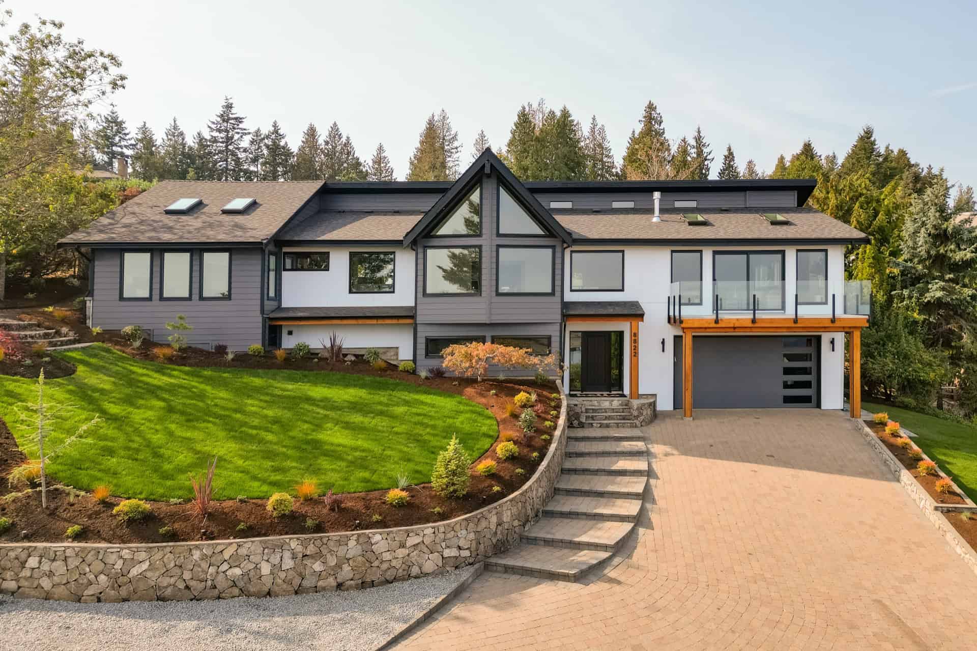 Luxurious Victoria BC custom home by White Wolf Homes with modern design and landscaped yard.