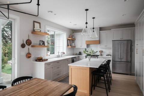 White Wolf Homes kitchen in Copperwood project with island and vaulted bright space.