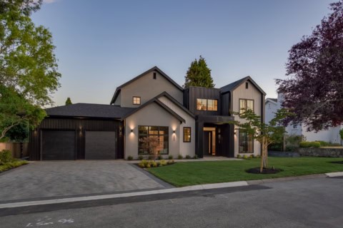 Modern two-story custom home in Victoria BC by White Wolf Homes with a three-car garage and manicued.