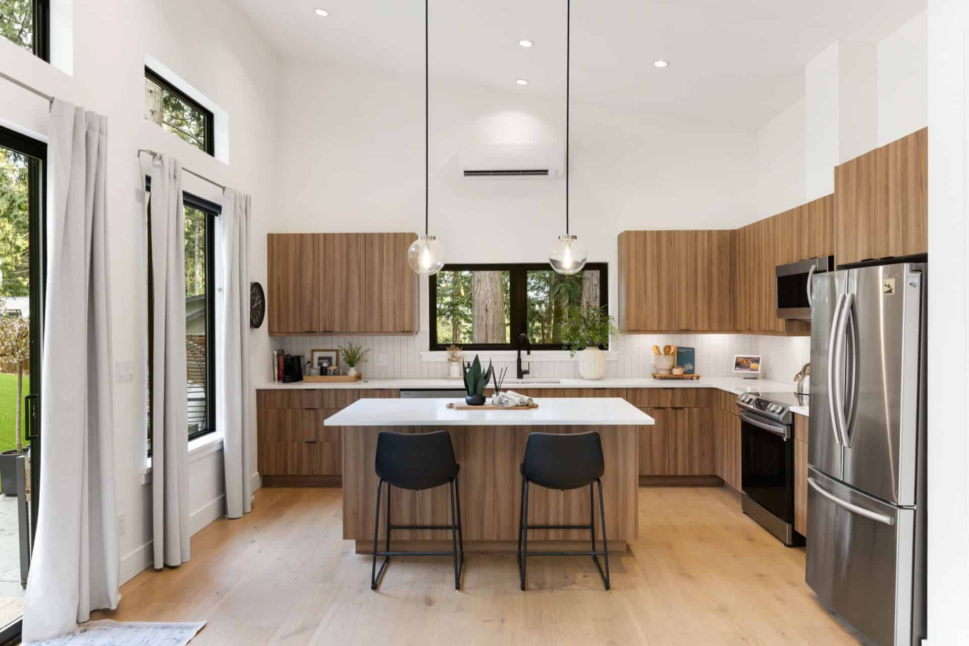 Modern kitchen with wooden cabinets, island and stainless steel appliances in Victoria BC home.