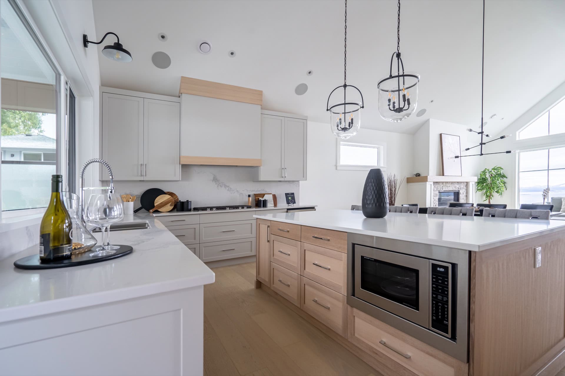 Bright modern kitchen with white cabinets and island, Victoria BC custom home.