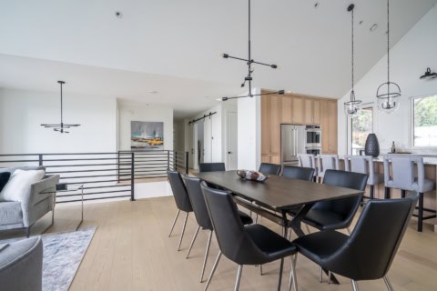 Open-concept dining room and kitchen in a modern Victoria BC home by White Wolf Homes.