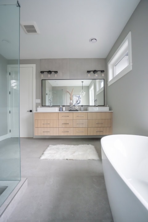 Custom home bathroom by White Wolf Homes in Victoria BC, modern dual vanity, freestanding tub, glass.