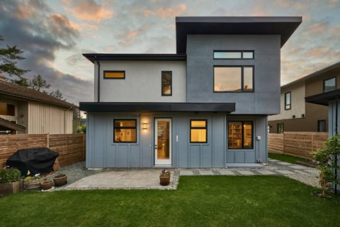 Modern two-story Victorian-style home with blue siding and large windows in Victoria BC.