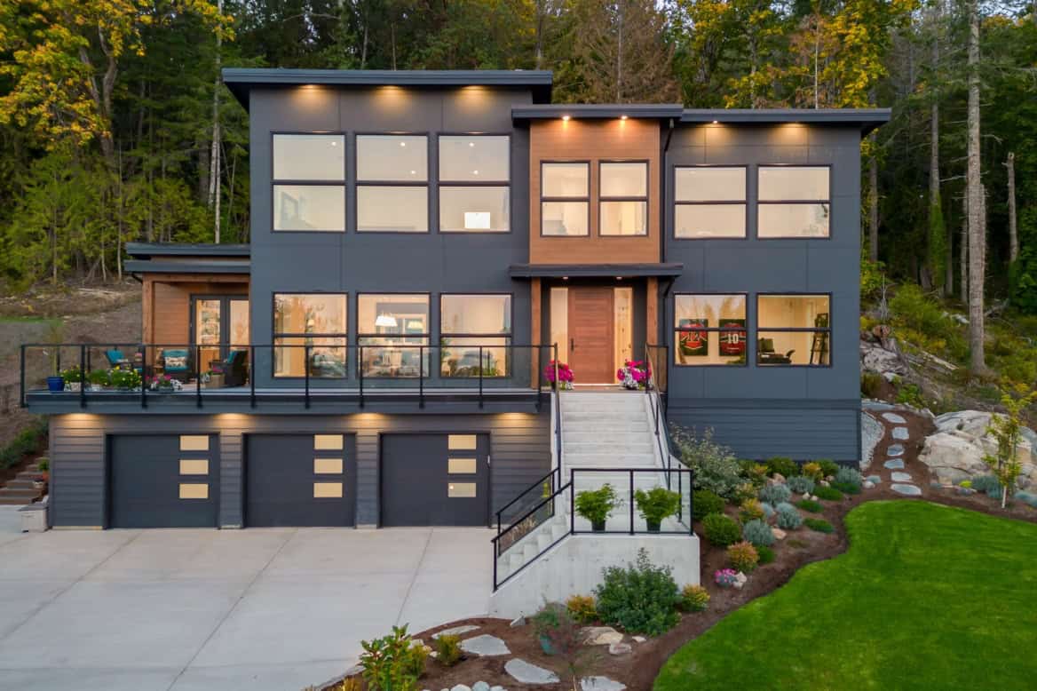 Modern custom home by White Wolf Homes in Victoria BC with dark gray exterior and large windows.