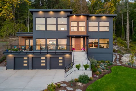 Modern custom home by White Wolf Homes in Victoria BC with dark gray exterior and large windows.