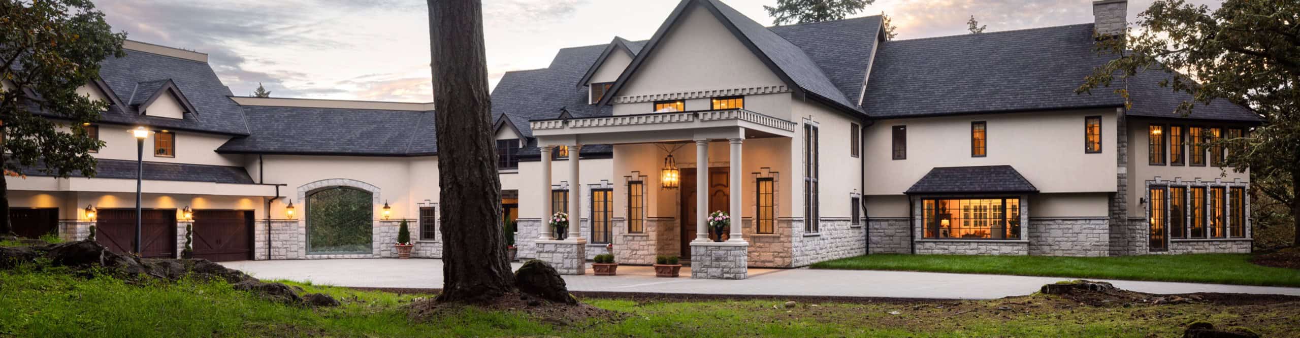 White Wolf Homes custom home exterior in Victoria BC with porte-cochere and stone accents.