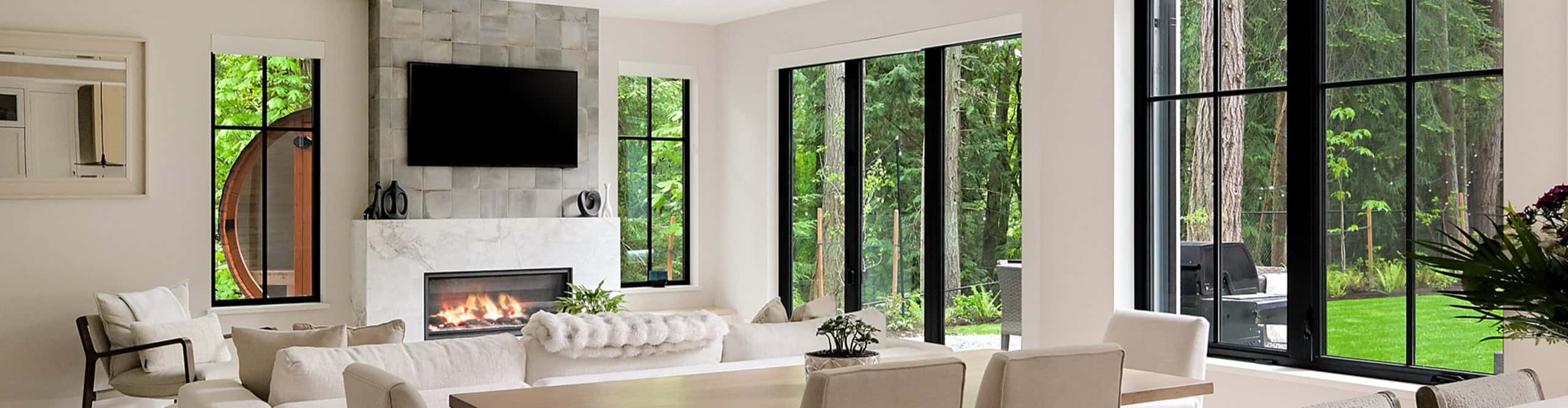 Bright modern living room with fireplace and large windows.